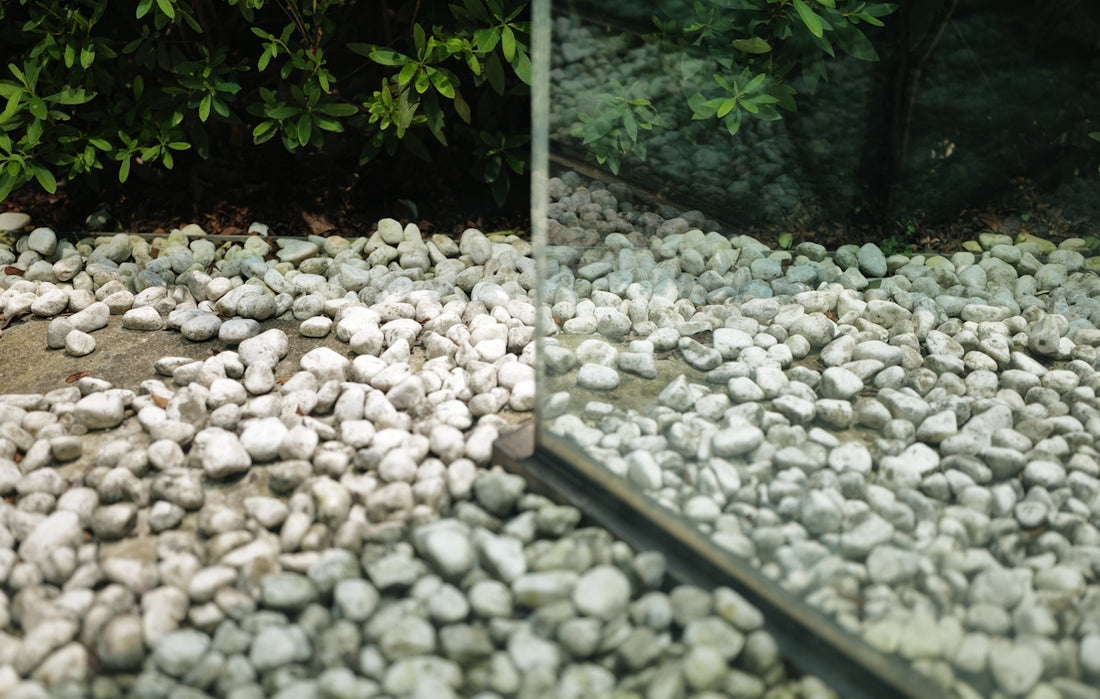 a mirror sitting on top of a pile of rocks