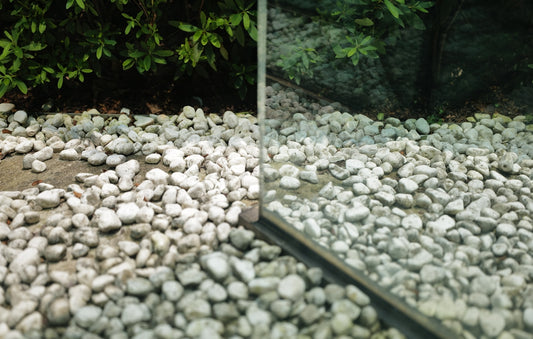 a mirror sitting on top of a pile of rocks