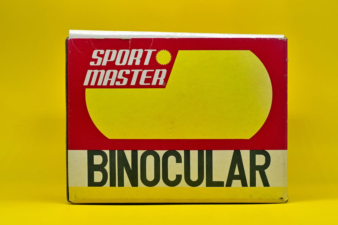 a box of sports master binoculars on a yellow background