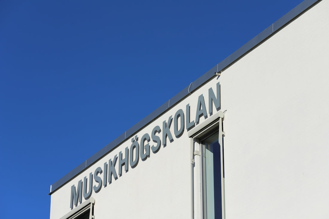 A white building with a sign on the side of it
