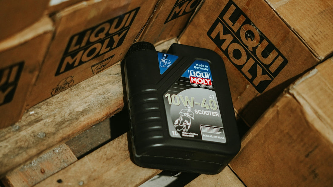 Oil bottle rests among stacked boxes.